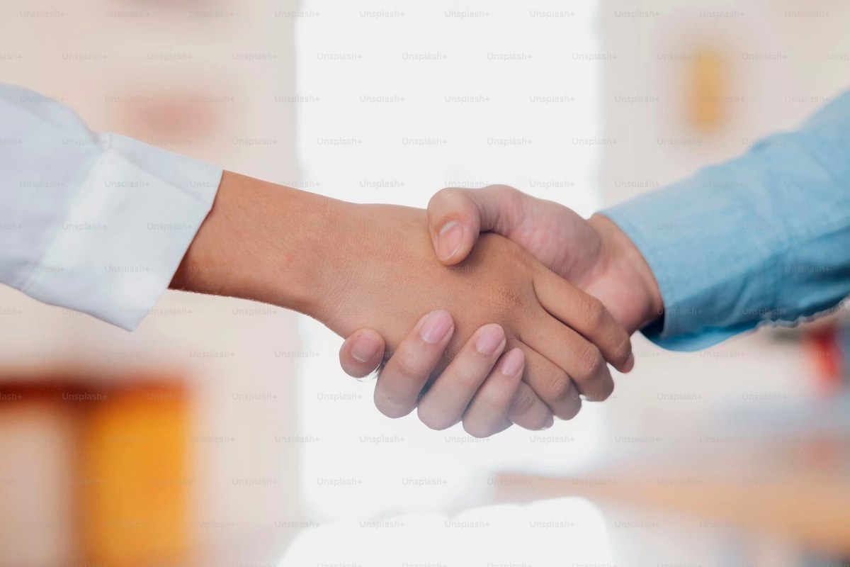 Business partnership handshake
